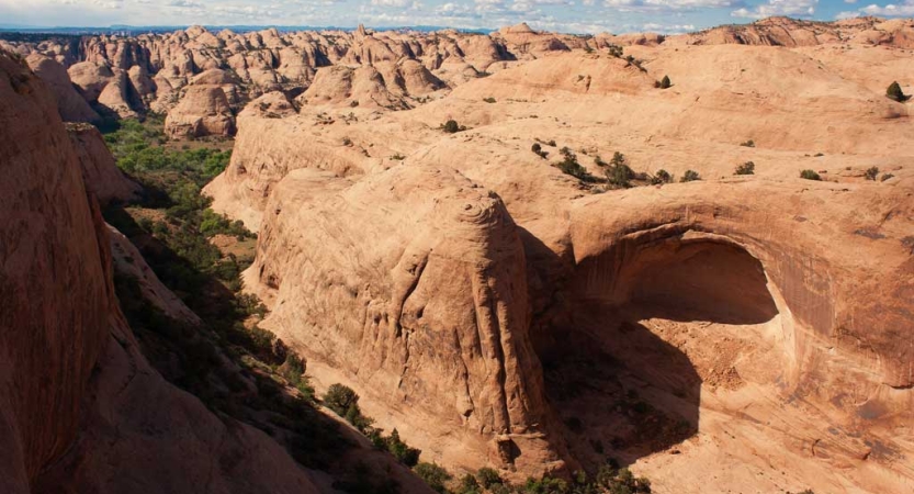 From above, a vast, high desert landscape stretches out below. 